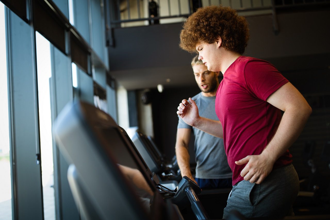 Man exercising with personal trainer