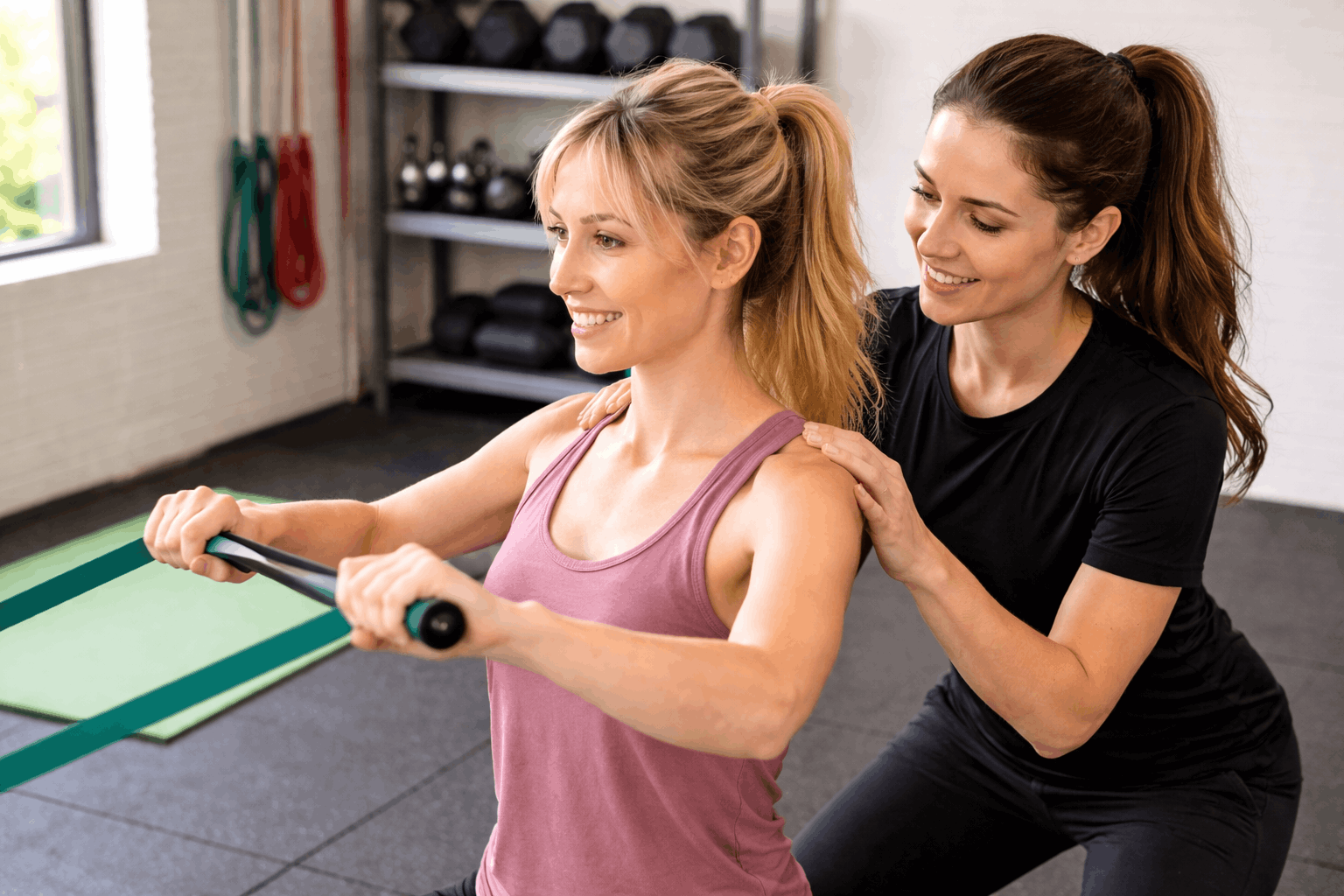 gym vs coaching personal trainer guiding client workout